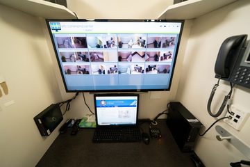 A monitoring station with a wall of screens